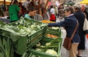 A local buys her weekly fresh produce from the farmers' market in Hall in Tyrol.