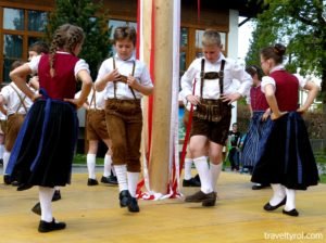 Children dancing around a Maypole in Austria.