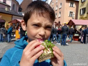 Tyrolean eating radish sandwich.