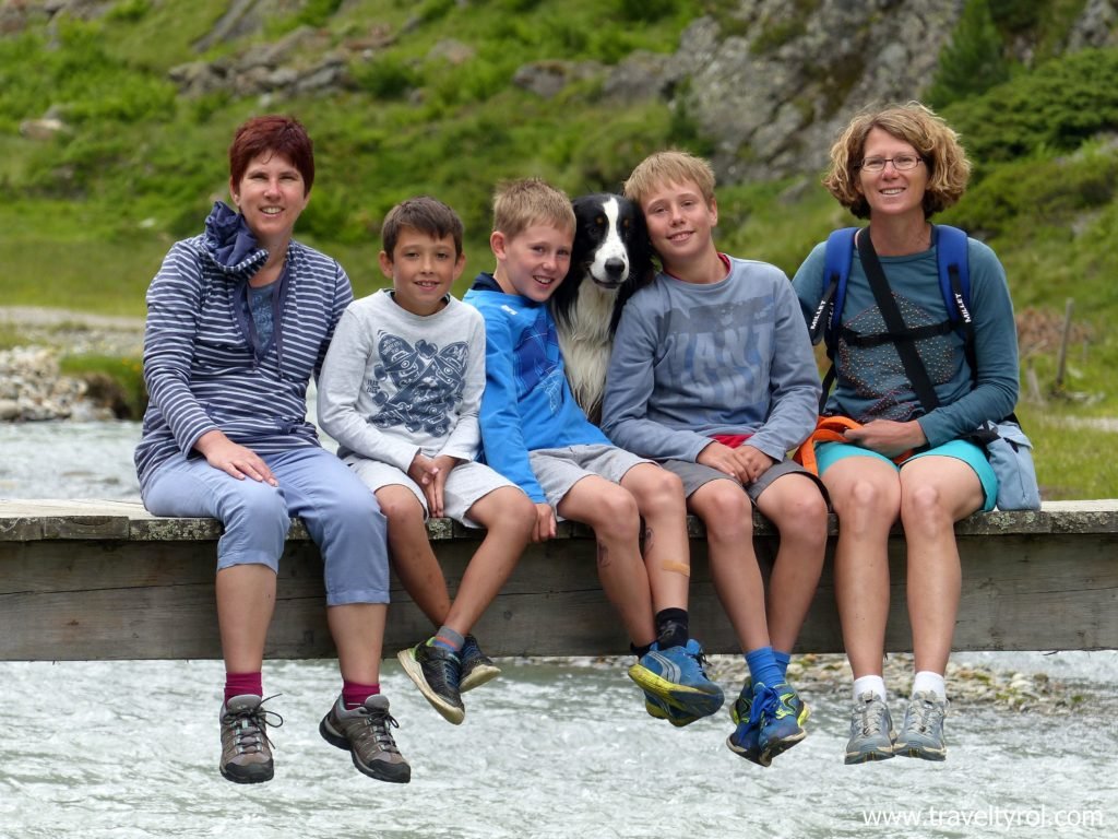 Hikers on a bridge on the Wilde Wasser Weg in Austria's Stubai Valley.