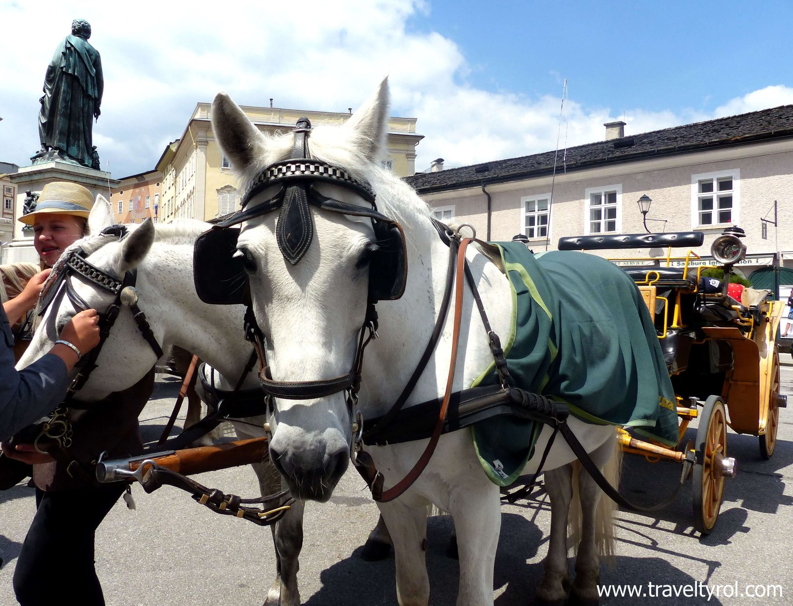 The tourist information office where you buy the Salzburg Card is on Mozart Square where the horse carriages depart from.