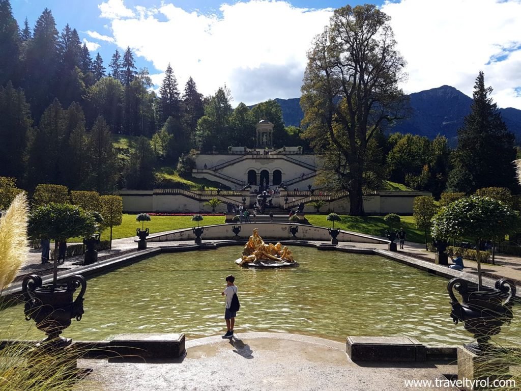 Linderhof Palace fountain and lime tree in garden.